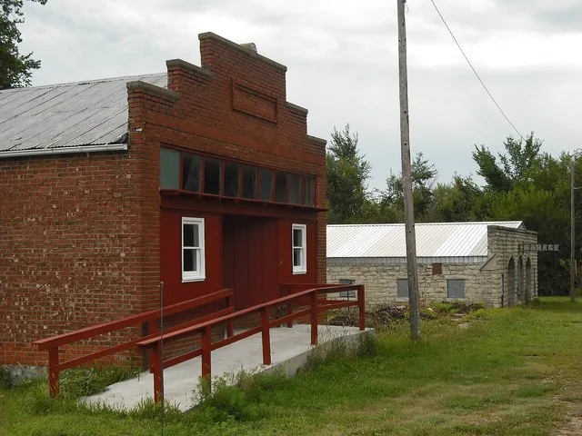Two buildings in Bushong, Kansas. The building in the foreground is an old store and the other building is an old garage.