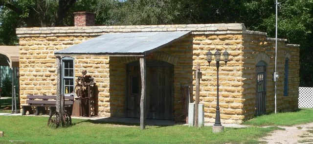 Blacksmith shop, located on north side of Lynn Street west of Baird Street in Cuba, Kansas; seen from the southeast.