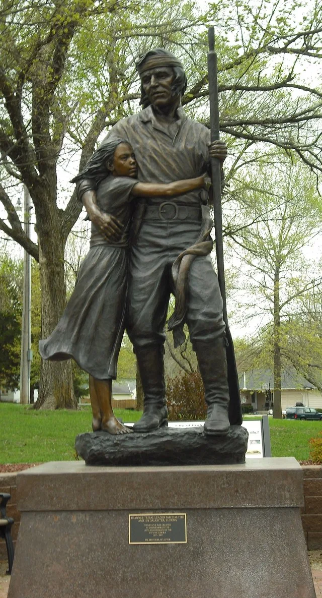 Pascal and Eudora Fish statue in Eudora City Park in Eudora, Kansas. Pascal lived in the Eudora area when the town founders arrived. The town is named for his daughter, Eudora.