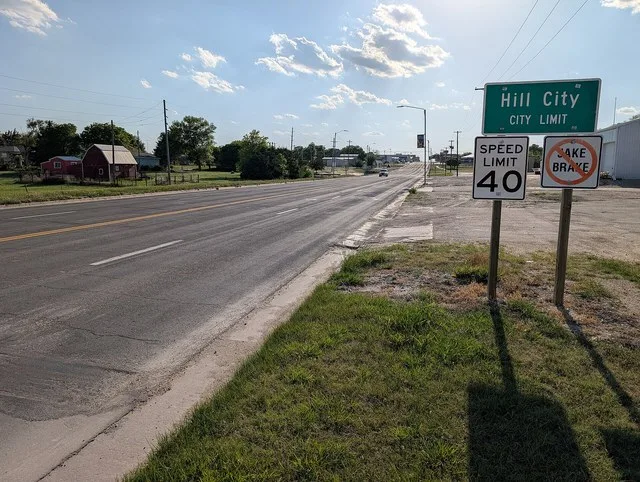 Looking up the road by the City Limit sign for Hill City, Kansas