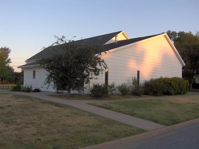 Eastern side and rear of the Minneola Reformed Presbyterian Church , located at 405 Locust Street in Minneola , Kansas , United States .