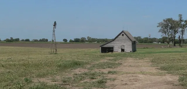 Shimanek barn, located near northwest corner of county roads 200 and Hickory, about one mile south of Munden, Kansas; seen from the south. Munden's water tower is visible in the b...