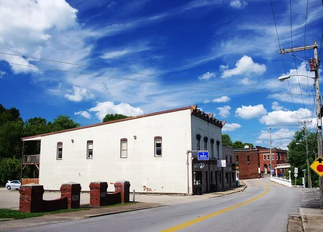 Kentucky Route 48 (Fairfield Hill Road) in Bloomfield, Kentucky, United States. The Medica Pharmacy and Bloomfield Barbershop occupy the building on the left.