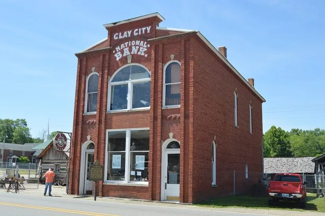 Front and northwestern side of the Clay City National Bank Building , located on the southwestern side of Main Street (Kentucky Routes 11 / 15 ) in central Clay City , Kentucky ...