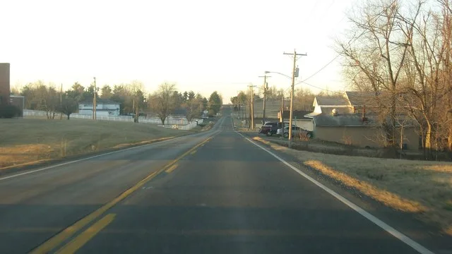 Looking southward on Adams Avenue ( U.S. Route 431 ) north of the Hiland Avenue intersection in Island , Kentucky , United States .