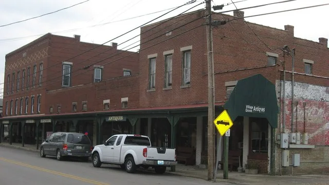 Buildings on the western side of Main Street ( Kentucky Route 101 ) in Smiths Grove , Kentucky , United States . The taller buildings were constructed in 1908 (three-story) and 19...