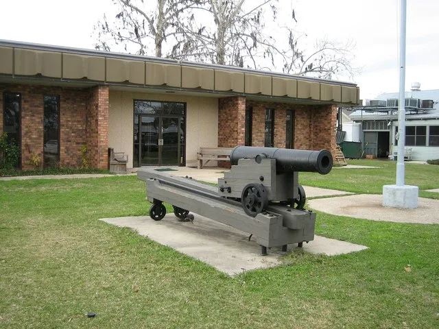 Old cannon with recoil ramp, in front of Town Hall of Madisonville, Louisiana. The cannon is a 24-pounder flank howitzer.