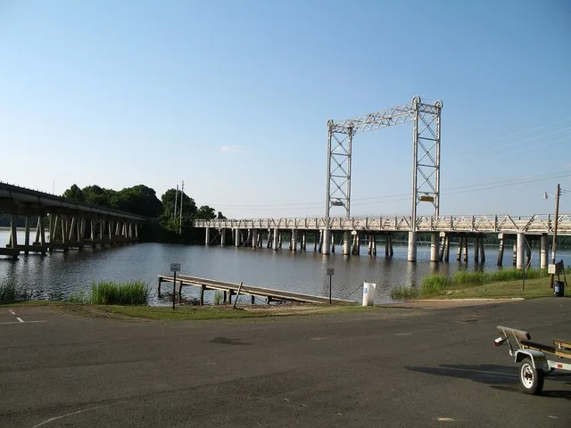 The Caddo Lake Drawbridge , in Mooringsport, Louisiana, is a 1914-built former-vertical-lift bridge. The lift span's counterweights were removed in the 1940s, and the lift span ha...