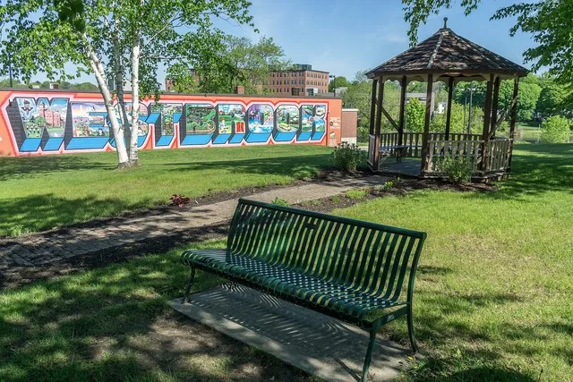 This sign and gazebo are across the street from the library in Westbrook, Maine. The mural was a project of Westbrook Arts & Culture, painted by aerosol artist Mike Rich and funde...