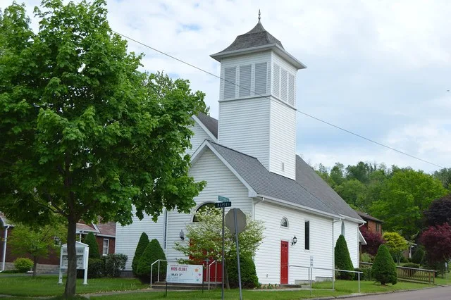 Front and western side of Grace Lutheran Church, located on the southeastern corner of the junction of Second and Maple Streets in Friendsville , Maryland , United States .
