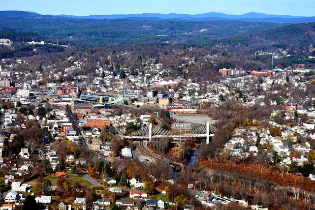 Aerial view of central area of Fitchburg, Massachusetts, including Nashua River, rail tracks, and commuter rail station.