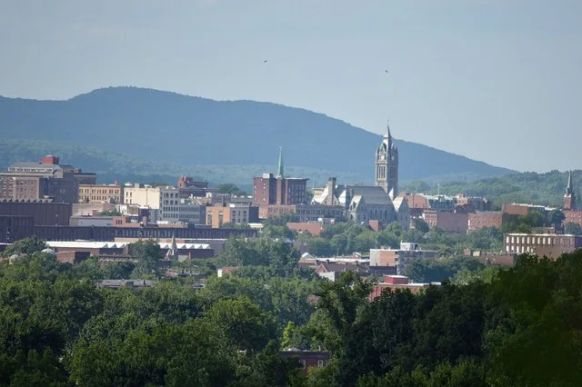 The skyline of Holyoke, Massachusetts , as seen from Chicopee , in the background the Mount Tom Range is visible, specifically Whiting Peak (left) and Mount Nonotuck (right). In t...
