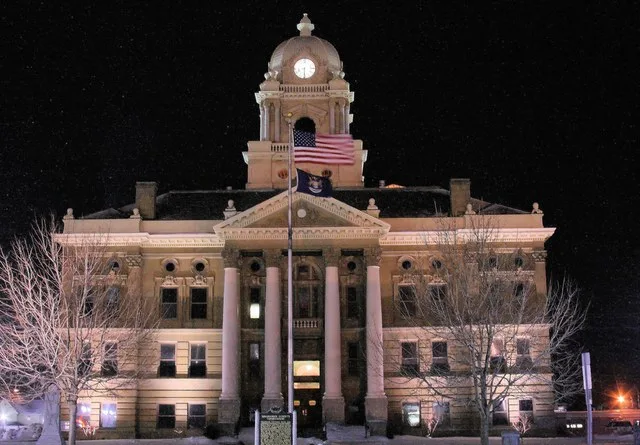 The MSHS- and NRHP-listed Shiawassee County Courthouse in Shiawassee County, Michigan, at night.