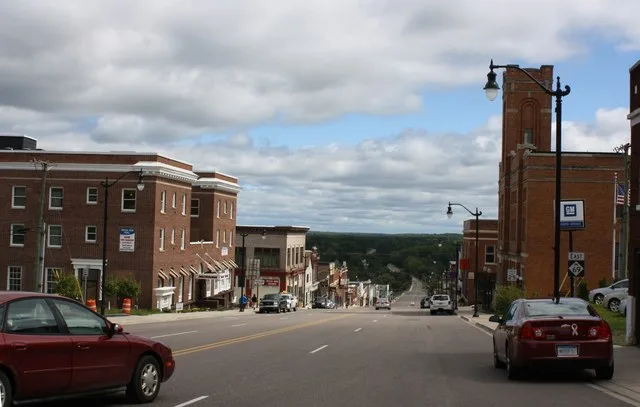 Looking west at downtown Crystal Falls at the western terminus for M-69 .