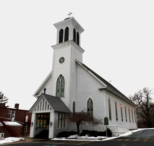 The St John the Baptist Catholic Church, located at 324 S Washington St, Hubbardston, MI.
