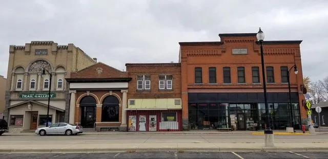 Buildings at the intersection of Railroad Avenue and 4th Street in Albany, Minnesota. Stores pictured include the Lake Wobegon Trail Gallery and Albany Country Floral & Gifts