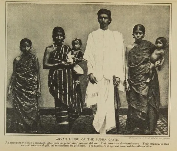 Aryan Hindu of the Sudra Caste. An accountant or clerk in a merchant's office, with his mother, sister, wife and children. Their sarees are of coloured cotton. Their ornaments in...