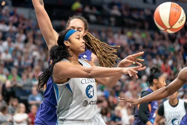 Alaina Coates passes the ball and is guarded by Brittney Griner