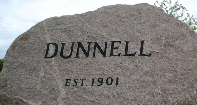 Photo I took 2006-05-21 of welcome sign for Dunell, Minnesota. CC & GFDL.