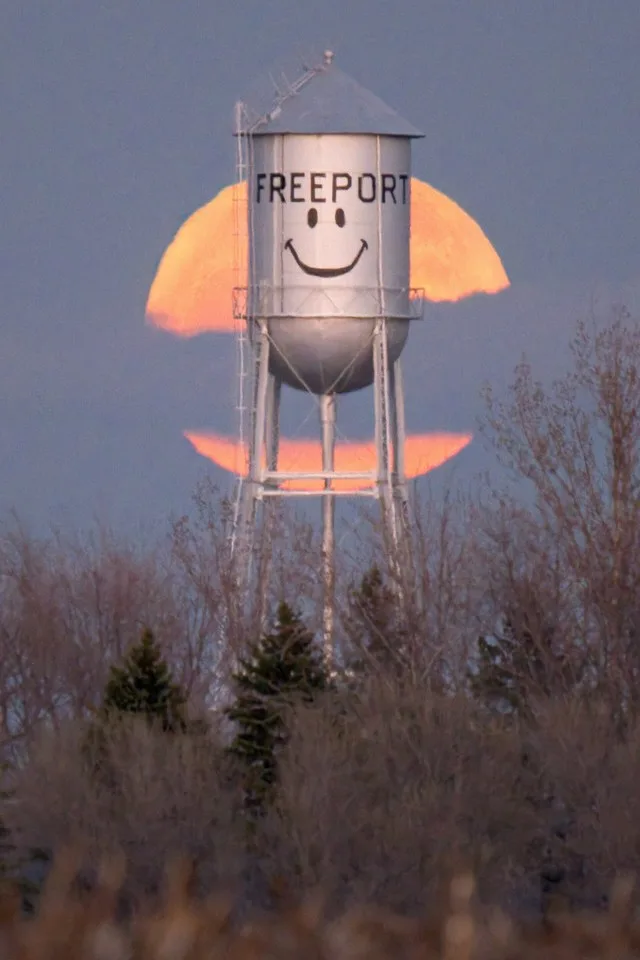 An April Full Pink Moon graces the Freeport smiley water tower, a Central MN landmark for decades.