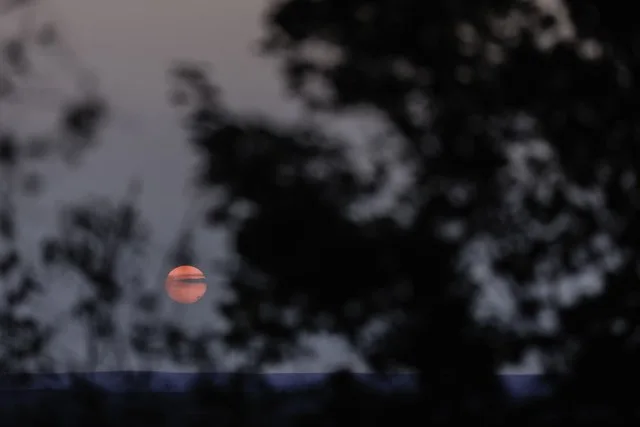 Hazy setting sun seen in Hoyt Lakes from smoke from the Greenwood fire burning in the Superior National Forest in Northern Minnesota
