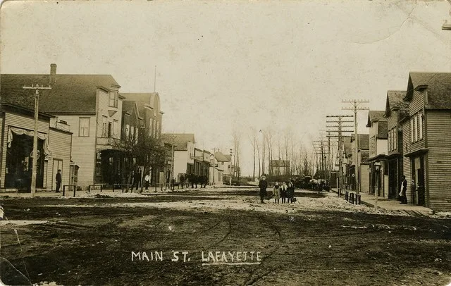 Many of the stores in the business district of Lafayette, MN are shown in this image.