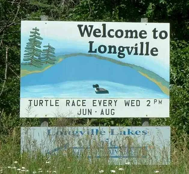 A welcome sign in the town of Longville, Minnesota, advertising its "turtle races every Wed." in the summer.