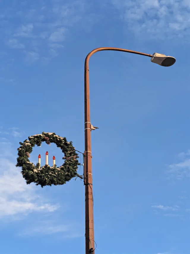 A snow-covered, pole-mounted Christmas decoration, typical of small towns in the Midwest, on display in Madelia, Minnesota.