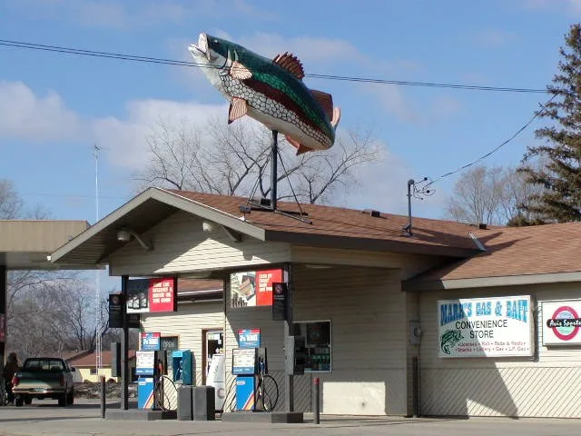 Store with sign in form of fish. Broadway at Mill Street, Rockville, Minnesota, USA. Taken by William Wesen