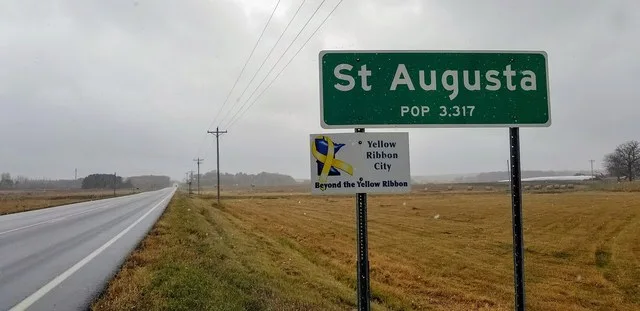Road sign for St. Augusta, Minnesota, population 3,317