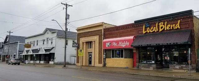 Shops on West Minnesota Street in St. Joseph, Minnesota. Businesses shown include The Local Blend coffee shop, The Middy bar, Rockhouse Productions (in the old First State Bank bu...