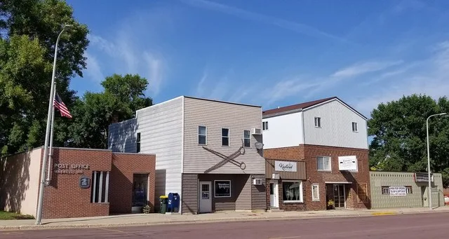 Buildings on Main Street in Wabasso, Minnesota, including the Wabasso post office, a hairstylist, and a meat market