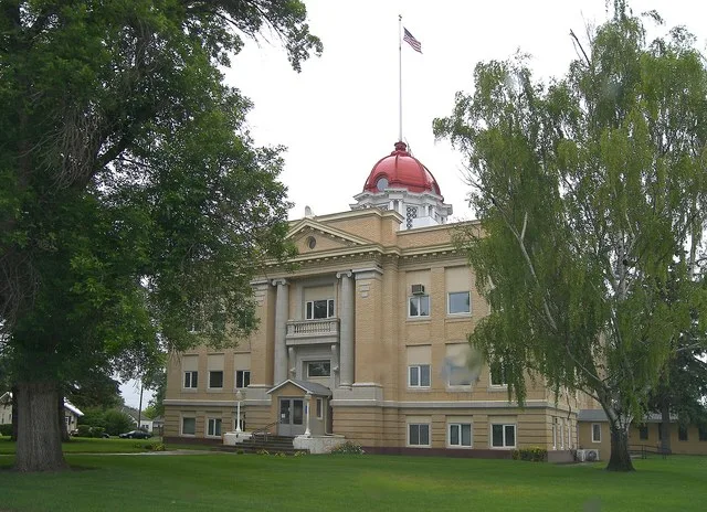 The Richland County, Montana Courthouse located in Sidney, Montana, United States. The image was taken through a windshield on a rainy day so there are a couple of rain drops wort...