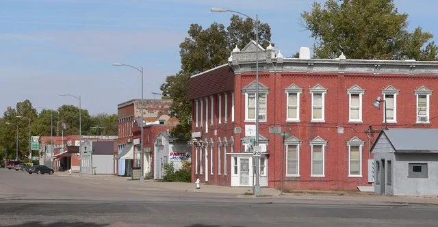 Downtown Edgar, Nebraska : east side of C Street, looking northeast from about the Union Pacific Railroad tracks south of 2nd Street. The two-story red brick building in the right...