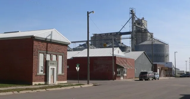 Downtown Holstein, Nebraska : east side of Main Avenue, looking southeast. The street intersection in the center of the photo is that of Main Avenue, running north-south, and Fill...