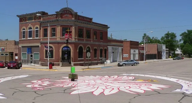 Downtown Loup City, Nebraska : northwest corner of 7th and O Streets, seen from the southeast. O Street runs westward, to the left; 7th runs north, to the right. The painting on t...