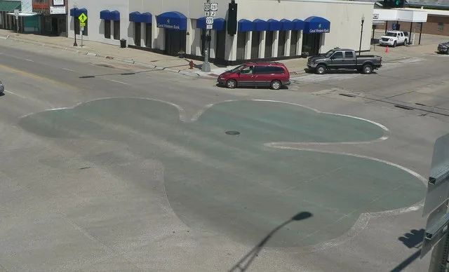 Shamrock painted on pavement at intersection of 4th and Douglas Streets in O'Neill, Nebraska .