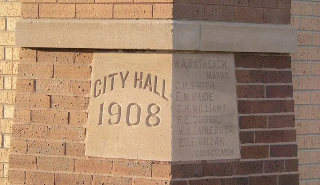 Cornerstone at northwest corner of Schuyler City Hall in Schuyler, Nebraska . The building was constructed 1908, and is listed in the National Register of Historic Places .