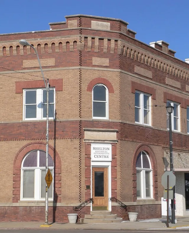 Southeast corner entrance of Shelton Historical Interpretive Center, formerly the Meisner Bank , at the corner of U.S. Highway 30 and C Street in Shelton, Nebraska . The Renaissan...