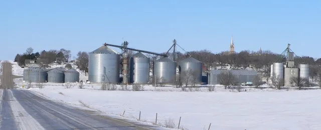 Tarnov, Nebraska , seen from the east. In the foreground are grain elevators along the tracks of the Nebraska Central Railroad ; atop the hill right of center is the steeple of St...