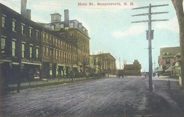 Main Street, Somersworth, NH; from a c. 1910 postcard. The tall building is the Great Falls Hotel, built by the Great Falls Mfg. Co. in 1825.