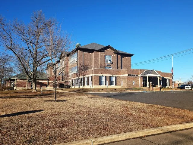 Photo of the Alice Costello School building Brooklawn , New Jersey . The building has additions containing the Brooklawn Borough Hall, the Brooklawn Police Department, and the Flo...