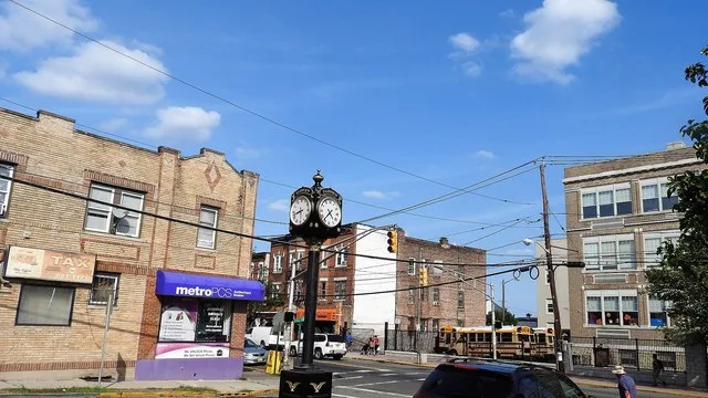 Looking east at central square with town clock on a sunny afternoon