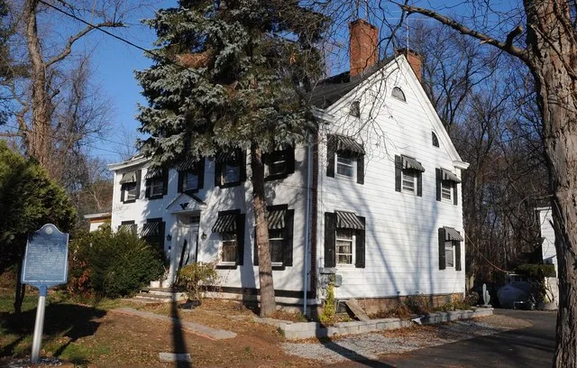 BUILT CIRCA 1810 IN GREEK REVIVAL STYLE BY JOHN DEMAREST WHO WAS A FARMER WITH AN INTEREST IN RIVER TRADE USING THE HACKENSACK RIVER. HOUSE WAS PURCHASED IN 1864 BY GEORGE BLOOMER...