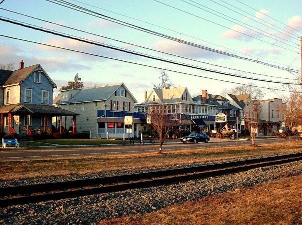 View of northern part of Palmyra, NJ near border with Riverton; shops along West Broad Street looking from across RiverLINE tracks.