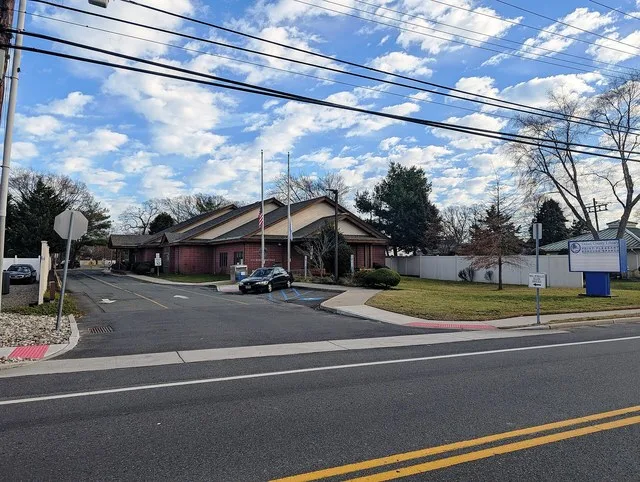 Photo of the Point Pleasant Borough Branch of the Ocean County Library in Point Pleasant , New Jersey . Photo taken from County Route 630 (Beaver Dam Road) looking east.