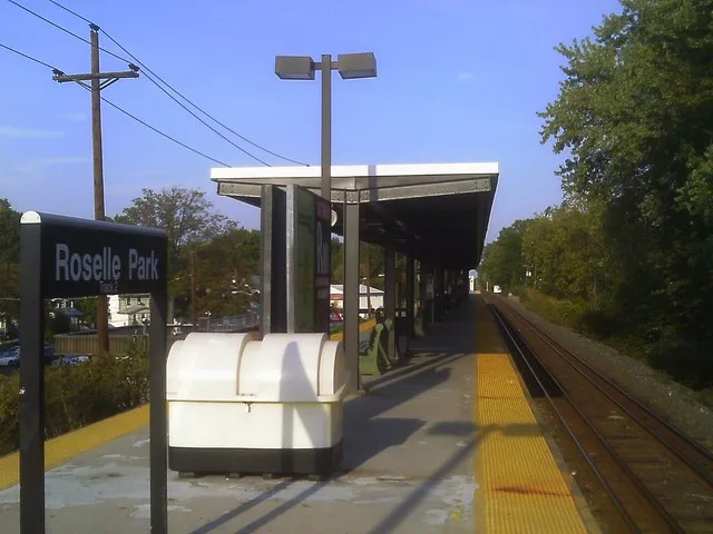 The Roselle Park station on New Jersey Transit's Raritan Valley Line. The view is facing northbound towards Union and Newark, New Jersey. The station depot is visible under the po...