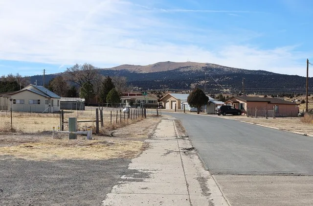Des Moines, New Mexico . The view is looking southwest along Olive Avenue near the post office. Sierra Grande , an extinct volcano, lies in the distance.