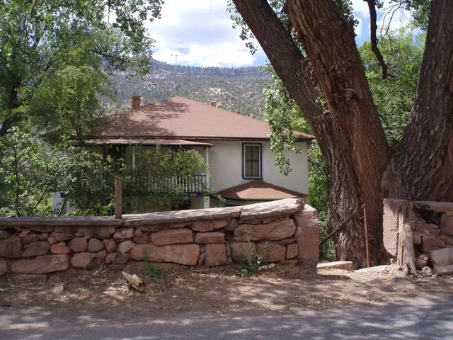 I always loved this house with its stone wall, and the cottonwood trees. When going north on this road, the houses and the left side are below the road, since they are on a slope...