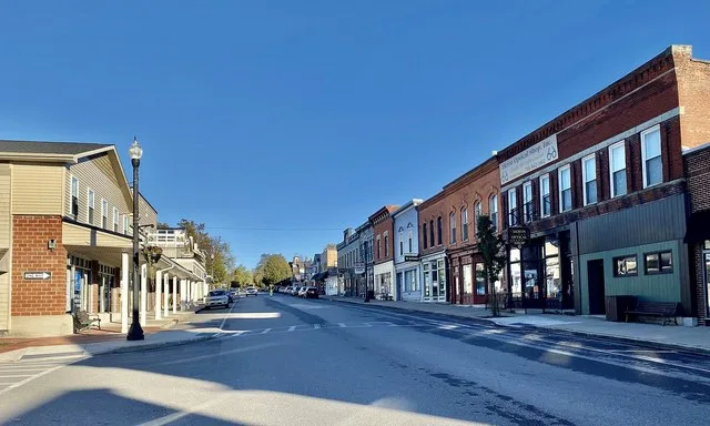 Looking eastward along Main Street from the corner of Monroe Street in the village center of Akron, New York on an October 2021 evening.